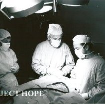 Dr. Ulpio Miranda, Dr. Jack Mahoney and OR nurse Barbara Wright in OR.